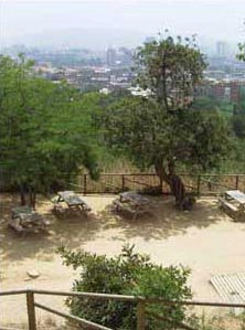 Oreneta Park Barcelona with picnic tables and benches and view of the city