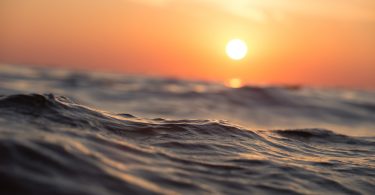 sunset above water