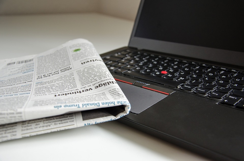 newspaper and laptop