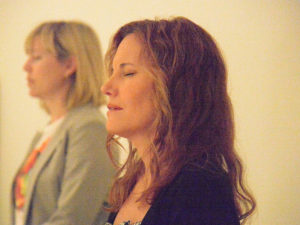 two women breathing with eyes closed