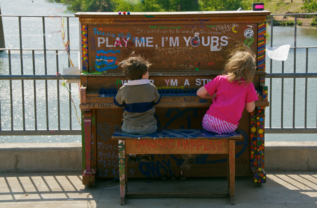 Boy and girl playing piano