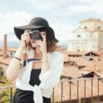 young-woman-wearing-straw-hat-photographing-old-town