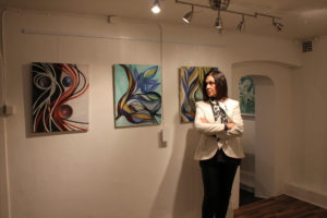 woman in the art gallery looking at some paintings