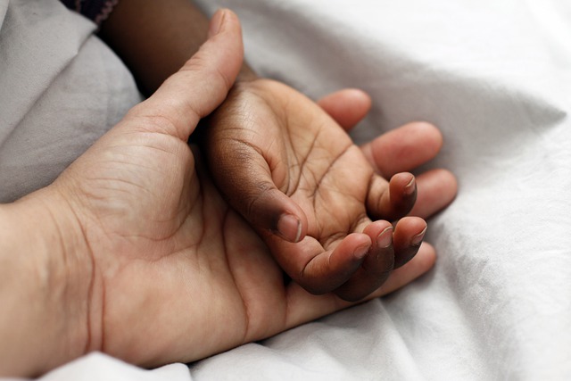 child's hand in parent's hand
