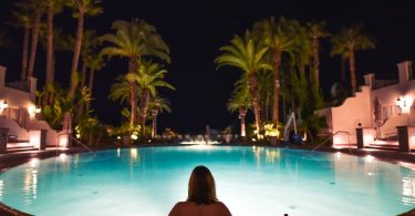 lady in pool by night