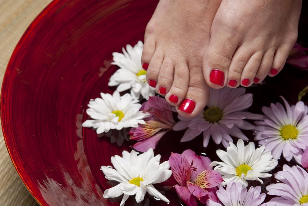 feet in water with flowers