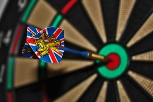 dart hits bulls eye on dart board