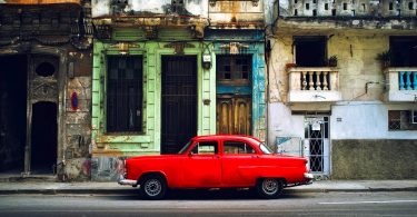 bright red car parked on side of the street