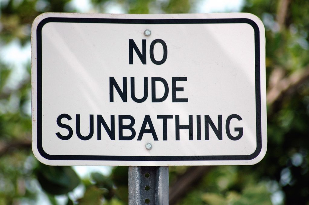 sign saying no nude sunbathing