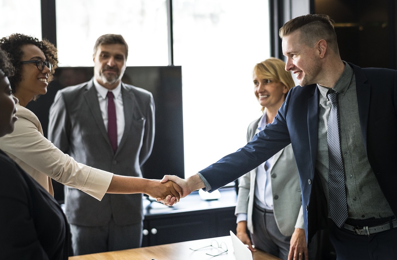 5 people with 2 shaking hands