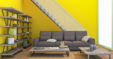 yellow wall with stairs and coach in front