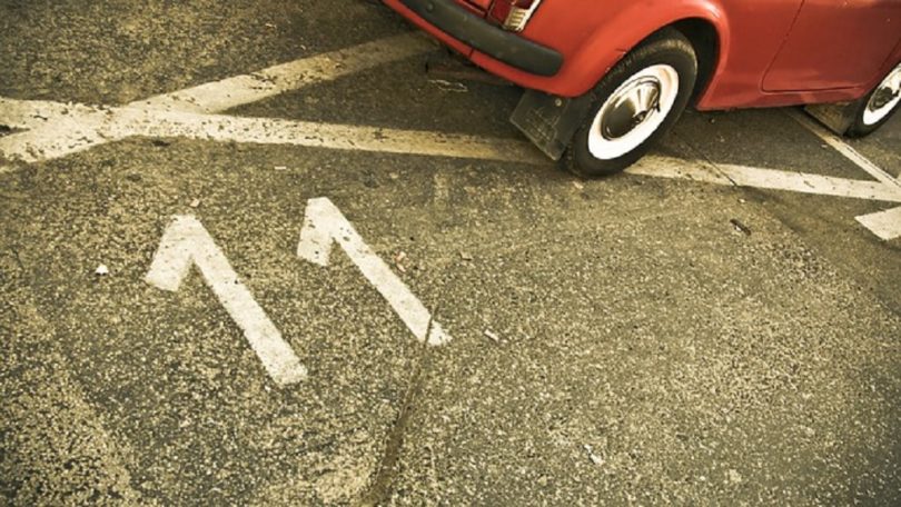 parking spot number 11 with red car