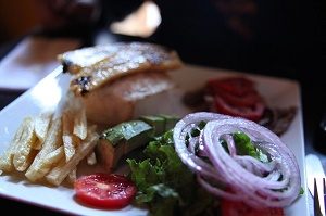 peruvian dish with fries and salad