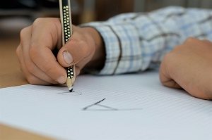 child practicing writing the lettre A