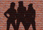 women's silhouette against brick wall