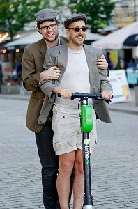 two men on an e-scooter