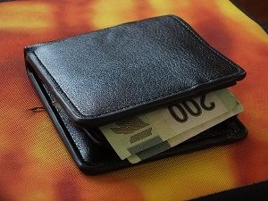 black wallet on table with 200 euro notes