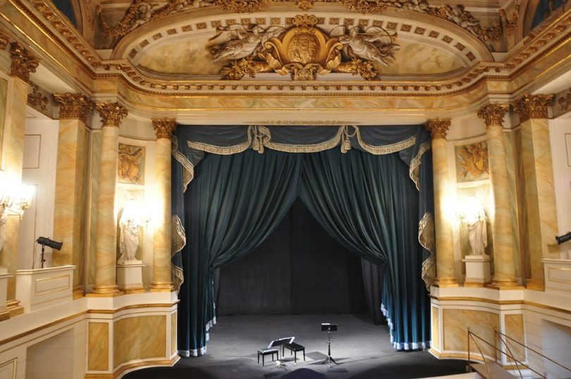 interior old theatre with blue curtains