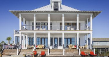 white, two story house with pool in front