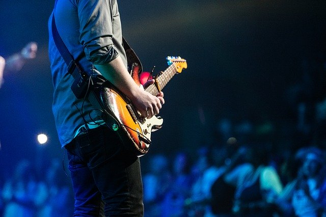 man with guitar at concert