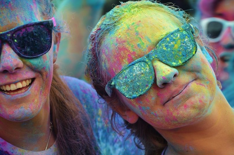 girl with sunglasses and coloured powder