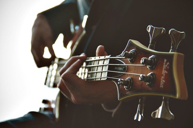 close up of guitar and hands