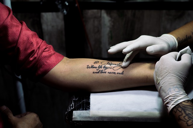 BARCELONA SPAIN  OCTOBER 3 2014 Closeuo Of Professional Artist Doing  Colorful Tattoo On Clients Leg The 17th Edition Of The Barcelona Tattoo  Expo In Fira De Barcelona Stock Photo Picture And