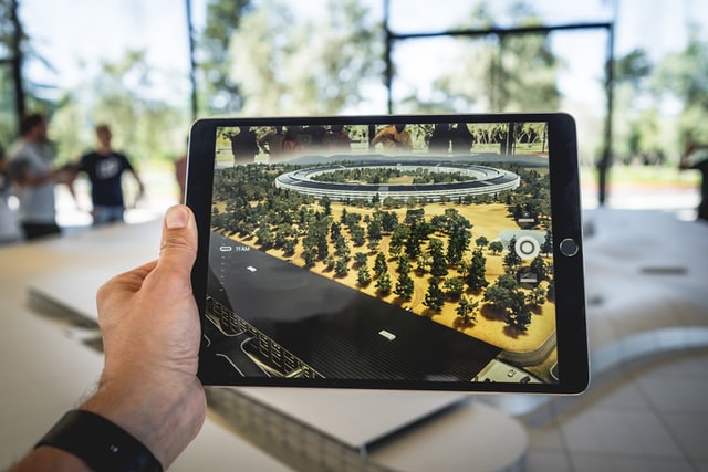 person holding black iPad photo, real estate trends