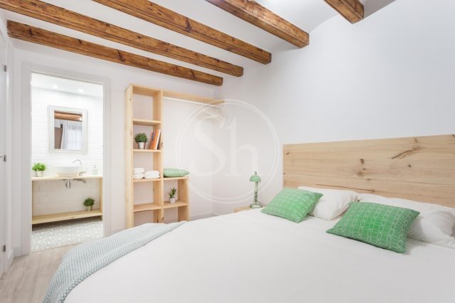 light bedroom with wooden beams