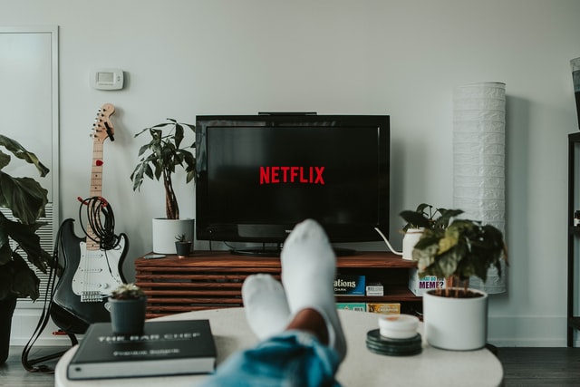 legs and feet in front of tv