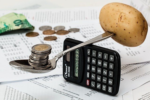 calculator with spoon, potato and coins