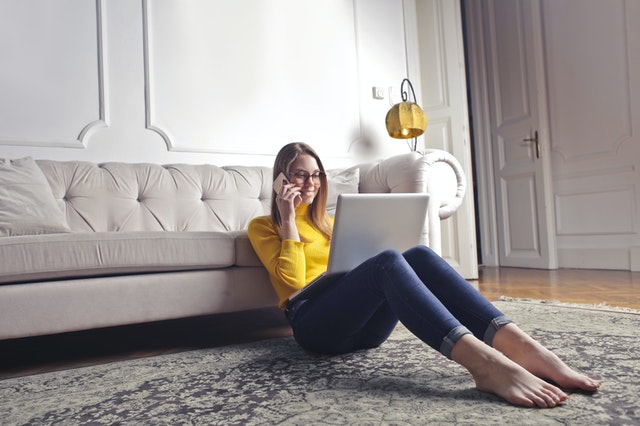 lady in yellow shirt sitting in front of couch