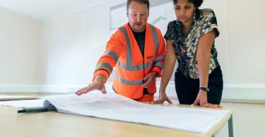 architect discusses building plan with lady