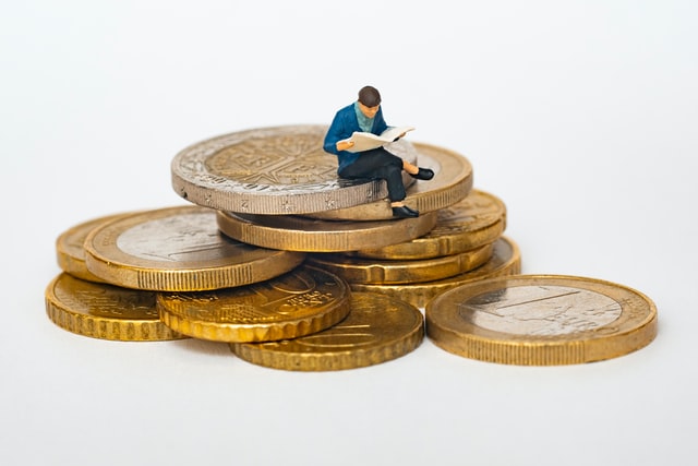 little man sits on coins