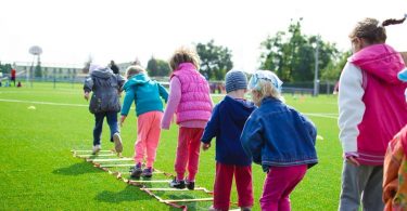 Une équipe d'enfants jouant sur l'herbe verte