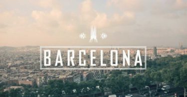 word barcelona with view of the city in background
