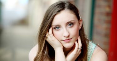 woman with brown hair looking in camera