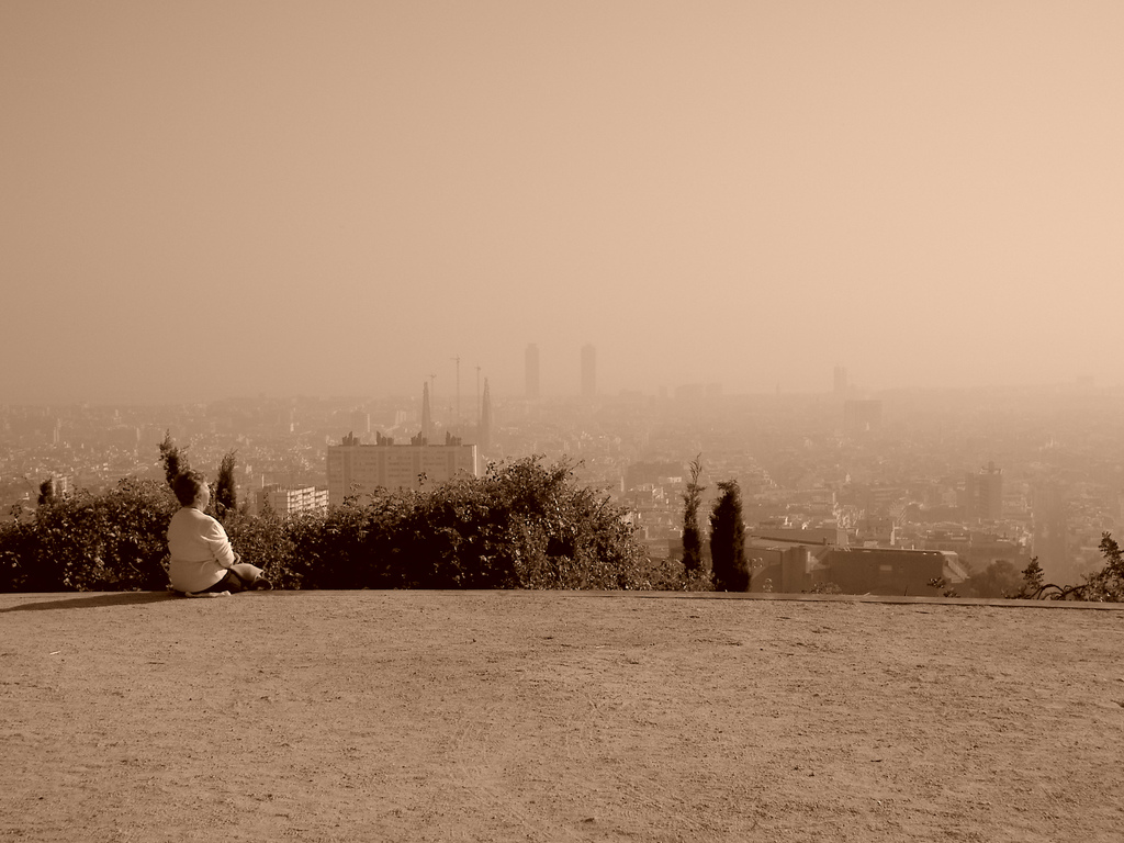 sitting and watching misty skyline barcelona