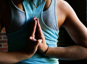 hands folded behind back