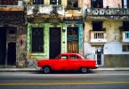 bright red car parked on side of the street