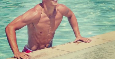 muscular man getting out of swimming pool