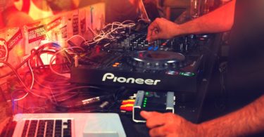 disc jockey on stage with red light