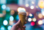 cone with ice cream and lights in the background