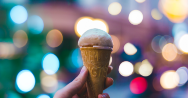 cone with ice cream and lights in the background