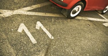 parking spot number 11 with red car