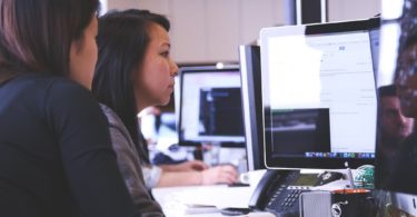 students sitting at computer doing project