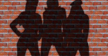 women's silhouette against brick wall