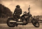 man sitting sideways on motorcycle
