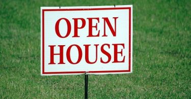 open house sign on lawn