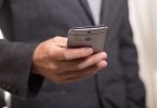 man in suit looking at phone
